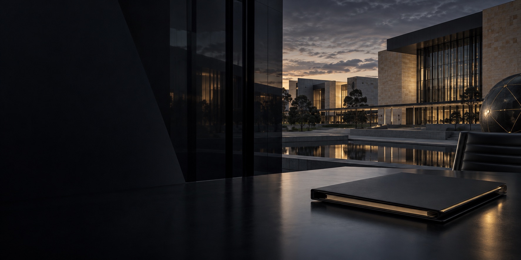 Dark contemporary civic precinct viewed through glass